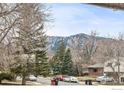 Street view of neighborhood with lush trees and view of mountains in the distance at 3605 Moorhead Ave, Boulder, CO 80305
