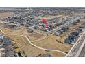 Aerial view of a neighborhood with walking trails and open spaces, with subject house indicated at 4764 Kipp Pl, Brighton, CO 80601