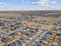 Aerial view of a residential neighborhood, with subject house indicated by the red arrow at 4764 Kipp Pl, Brighton, CO 80601