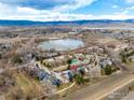 Beautiful aerial view showcasing the community, lake, and mountain range in the background at 4866 Brandon Creek Dr, Boulder, CO 80301