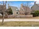 Home's backyard features a well-maintained wooden fence and mature trees for added privacy at 4866 Brandon Creek Dr, Boulder, CO 80301