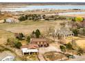 Stunning aerial view of a rustic home nestled on a large lot with a lake in the background at 4963 Kelso Rd, Boulder, CO 80301