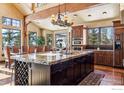 Beautiful kitchen with large center island, custom cabinets, granite counters, and stainless steel appliances at 500 Highfield Trl, Breckenridge, CO 80424