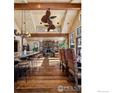 Spacious living room features a stone fireplace, wood floors, beamed ceilings and comfortable seating at 500 Highfield Trl, Breckenridge, CO 80424