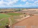 Aerial view of the property, showcasing boundary lines, farmland, home, barn, and surrounding landscape at 5139 County Road 38, Platteville, CO 80651