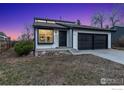 Well-maintained single-Gathering home with a two-car garage, stylish black trim, and a cozy front yard at 5780 S Parfet St, Littleton, CO 80127