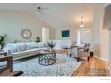 Spacious living room with hardwood floors, stylish rug, and plenty of natural light at 7051 Johnson Cir, Niwot, CO 80503