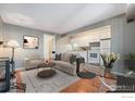 Cozy living room featuring hardwood floors that transition to a dining area and efficient kitchen at 8060 Niwot Rd # 17E, Niwot, CO 80503