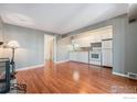 Living room featuring hardwood floors that transition to an efficient kitchen at 8060 Niwot Rd # 17E, Niwot, CO 80503