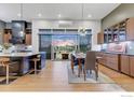 Well-lit kitchen with stainless steel appliances, lots of cabinets, an island, and dining table by a window at 8568 Foxhaven Ct, Niwot, CO 80503