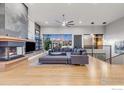 Stunning living room features a modern fireplace, hardwood floors, and a comfortable gray sofa at 8568 Foxhaven Ct, Niwot, CO 80503