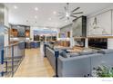Open-concept living room boasts a fireplace, hardwood floors, and seamless integration with the kitchen and dining area at 8568 Foxhaven Ct, Niwot, CO 80503