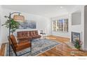 Bright living room with modern furnishings, a decorative rug, and a cozy fireplace at 930 Button Rock Dr # 80, Longmont, CO 80504