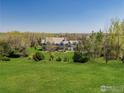 Expansive estate with lush green lawns, mature trees, and a beautiful home at 9610 Avocet Ln, Lafayette, CO 80026