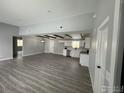 Bright living room and kitchen with modern finishes, wood-look floors, and lots of natural light at 11488 County Road 20, Fort Lupton, CO 80621