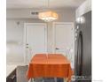 Dining area featuring table and chairs, modern lighting, and access to a closet at 1401 W 85Th Ave # B-405, Denver, CO 80260