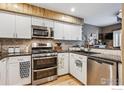 Well-lit kitchen featuring stainless steel appliances and ample cabinet space at 148 S Holman Way, Golden, CO 80401