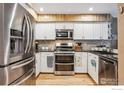 Stylish kitchen with stainless steel appliances, white cabinets, and wooden accents at 148 S Holman Way, Golden, CO 80401