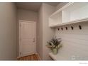 Inviting mudroom with built-in storage and a convenient bench area for easy organization when you enter your home at 15325 W 93Rd Ave, Arvada, CO 80007