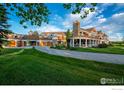 Beautiful home with a circular driveway, attached garages, and lush landscaping at 2300 N 75Th St, Boulder, CO 80301