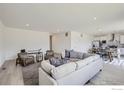 Bright and airy living room featuring hardwood floors, a large sofa, and an open floor plan at 2711 Crystal Springs Ln, Longmont, CO 80503