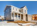 Charming two-story home showcasing a welcoming front porch and a two-car garage, perfect for Gathering living at 2718 Crystal Springs Ln, Longmont, CO 80503