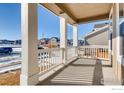 View from the porch showcasing its white railings and stately pillars at 2718 Crystal Springs Ln, Longmont, CO 80503