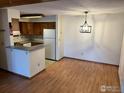 Dining area view adjacent to a kitchen with white appliances and tiled backsplash at 2992 Shadow Creek Dr # 203, Boulder, CO 80303