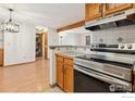 Bright, updated kitchen leads to the laundry area with a modern stainless steel oven at 2992 Shadow Creek Dr # 203, Boulder, CO 80303