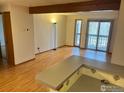 View of the living room with sliding doors to the deck, seamlessly connecting to the kitchen at 2992 Shadow Creek Dr # 203, Boulder, CO 80303