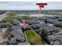 Aerial view of townhomes with a pond and Carpenter Park in the background at 3000 E 112Th Ave, Northglenn, CO 80233