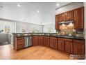 A kitchen featuring stainless steel appliances, wood cabinets, and hardwood floors at 3006 Thunder Lake Cir, Lafayette, CO 80026