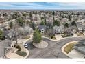 Residential aerial view showing a home at the end of a cul-de-sac in a neighborhood surrounded by mature trees at 325 Peregrine Cir, Broomfield, CO 80020