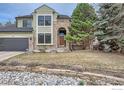 Two-story home featuring stone accents, a well-manicured front yard, and a unique stone-lined flower bed at 325 Peregrine Cir, Broomfield, CO 80020