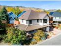 Charming two-story home featuring unique architecture, a covered porch, and lush landscaping at 3953 Springleaf Ln, Boulder, CO 80304