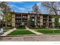 Multi-Gathering property showcasing mature trees and private balconies at 400 Emery St # 103, Longmont, CO 80501