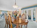 Well-lit dining room with a wooden table, plush chairs, and access to an outdoor patio at 43 Scott S Dr, Broomfield, CO 80020