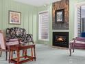 Cozy living room featuring a stone fireplace, plush seating, and soft, vintage-inspired decor at 43 Scott S Dr, Broomfield, CO 80020