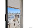 Covered patio offers an expansive view of the tranquil pond at 43 Scott S Dr, Broomfield, CO 80020