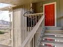 Exterior entryway with bright red door and stairway at 695 Manhattan Dr # 213, Boulder, CO 80303