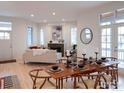 Bright dining room with hardwood floors, fireplace, and stylish furniture perfect for entertaining at 906 Confidence Dr, Longmont, CO 80504