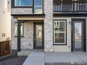 Inviting front entrance with stone detailing and a covered porch area at 928 Farrier Ln, Lafayette, CO 80026