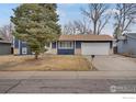 Inviting single-Gathering home showcasing mature trees and a well-maintained lawn at 12901 E Idaho Dr, Aurora, CO 80012