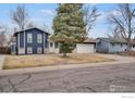 Suburban home with mature tree, featuring a well-manicured front yard and charming curb appeal at 12901 E Idaho Dr, Aurora, CO 80012