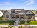 Stunning aerial view of a craftsman-style home with lush landscaping and a welcoming walkway at 1315 Burt Ave, Berthoud, CO 80513