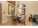 Charming dining area with large windows offering a view of the yard and neighborhood at 13238 Ivy Ct, Thornton, CO 80602