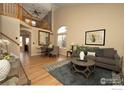 Spacious living room with high ceilings, hardwood floors, and plenty of natural light at 13238 Ivy Ct, Thornton, CO 80602