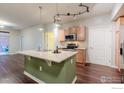 Open kitchen with island, stainless appliances, and a view to the patio at 13456 Via Varra # 114, Broomfield, CO 80020
