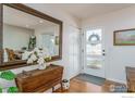 Bright foyer with a view to the dining room with hardwood floors and natural light at 1420 Fillmore Pl, Louisville, CO 80027