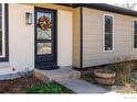 Inviting front entrance with decorative wreath, well maintained landscaping and neutral colors at 1420 Fillmore Pl, Louisville, CO 80027